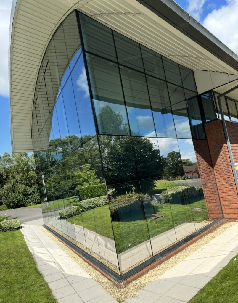 Reflective window film on a curved-roof commercial building