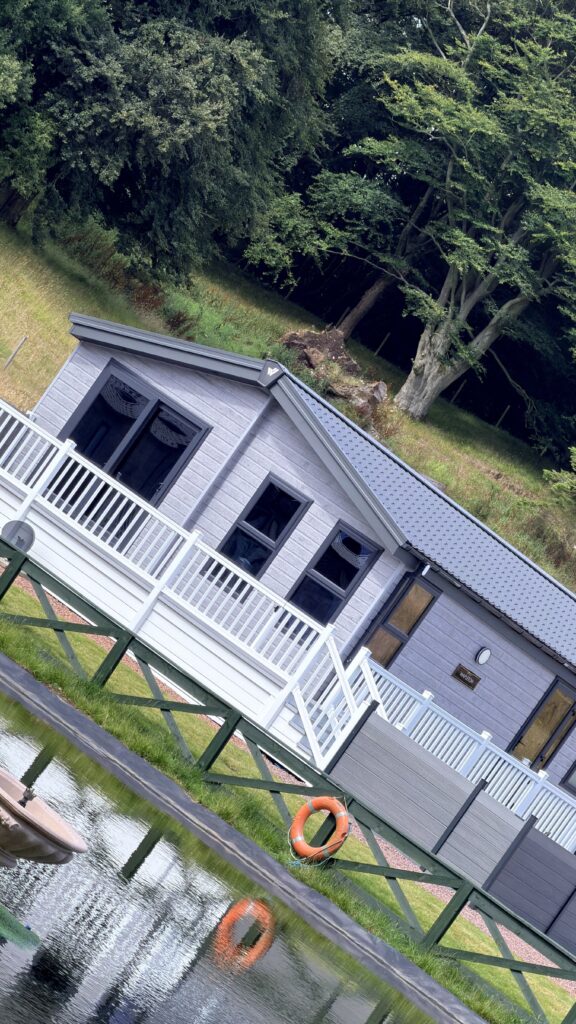 Window tinting on a holiday caravan beside landscaped gardens
