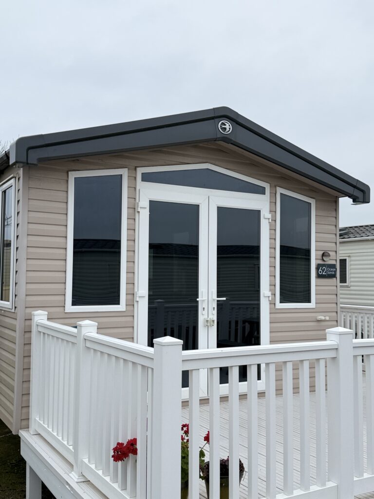 Window tinting on a static caravan with white decking